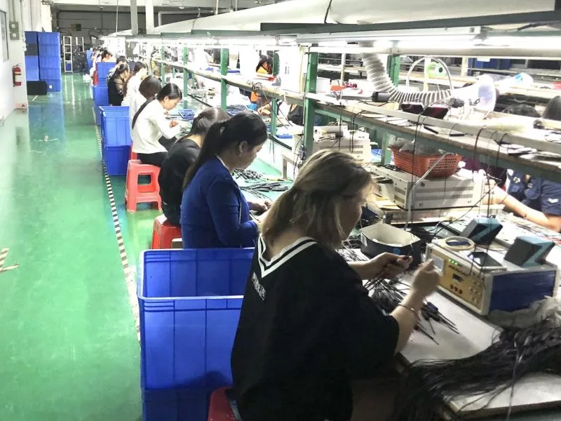 A modern, clean headphone factory in China with workers assembling products