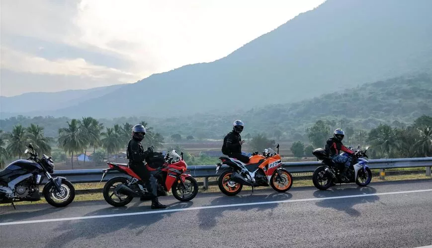 A group of young friends on motorcycles, all wearing stylish helmets with headsets